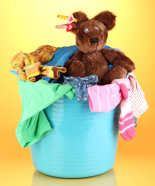 Blue laundry basket on orange background — Stock Photo, Image