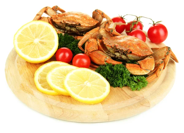 Boiled crabs with lemon slices and tomatoes, on wooden board, isolated on white — Stock Photo, Image