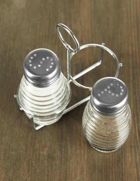 Salt and pepper mills, on wooden background — Stock Photo, Image