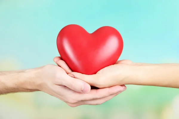 Heart in hands on nature background — Stock Photo, Image