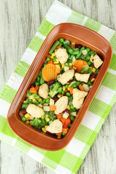 Casserole with vegetables and meat, on wooden background — Stock Photo, Image