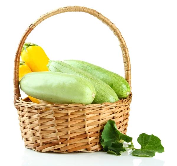 Raw yellow and green zucchini in wicker basket, isolated on white — Stock Photo, Image