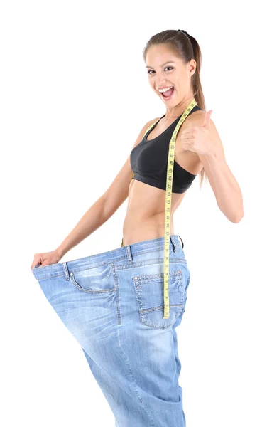 Menina magro em jeans grandes isolado em branco — Fotografia de Stock