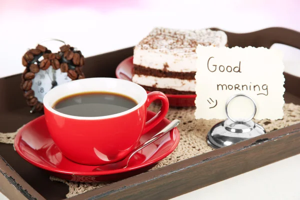 Cup of tea with cakes on wooden tray on table in room — Stock Photo, Image