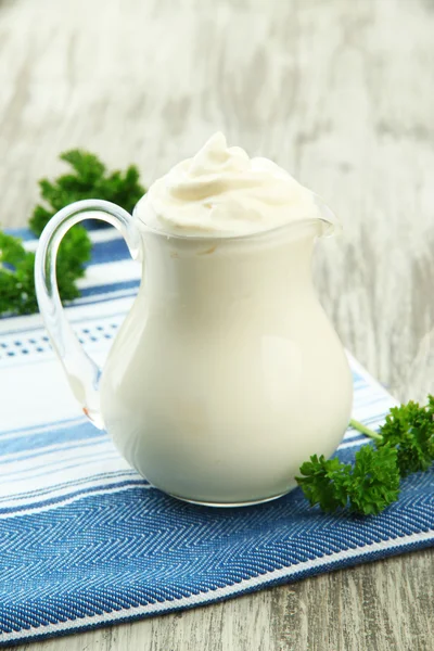 Sour cream in pitcher on table close-up — Stock Photo, Image