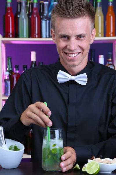 Portrait de beau barman préparant un cocktail, au bar — Photo