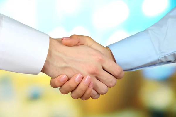 Business handshake on bright background — Stock Photo, Image