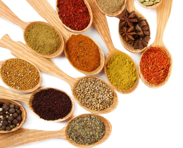 Assortment of spices in wooden spoons, isolated on white — Stock Photo, Image