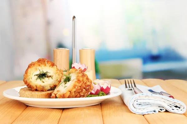 Chicken Kiev on croutons with mashed potatoes, on wooden table, on bright background — Stock Photo, Image