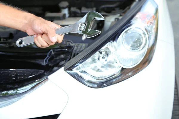 Hand mit Schraubenschlüssel. Automechaniker in der Autoreparatur — Stockfoto