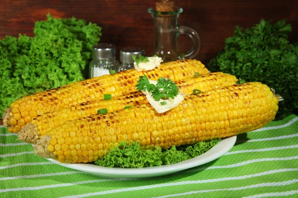 Delicious golden grilled corn with butter on table on wooden background — Stock Photo, Image