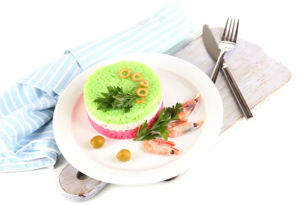 Colored rice on plate on wooden board near napkin isolated on white — Stock Photo, Image