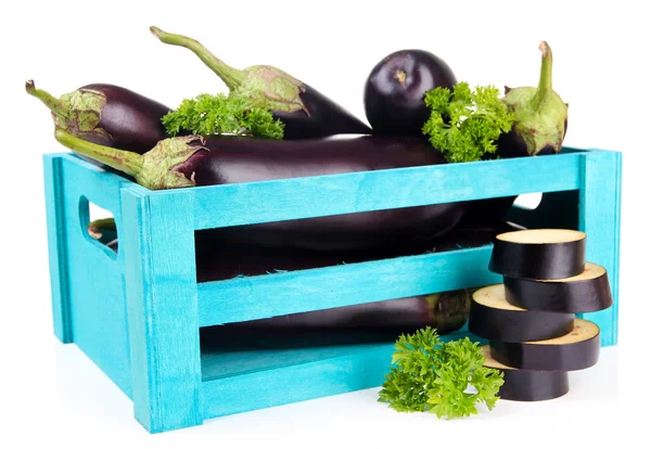 Fresh eggplants in wooden box isolated on white — Stok fotoğraf