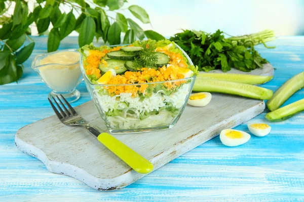 Deliziosa insalata con uova, cavolo e cetrioli sul tavolo di legno blu — Foto Stock