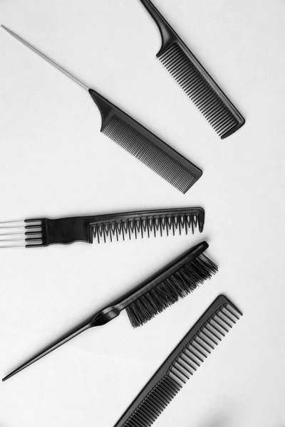 Black combs on gray background — Stock Photo, Image