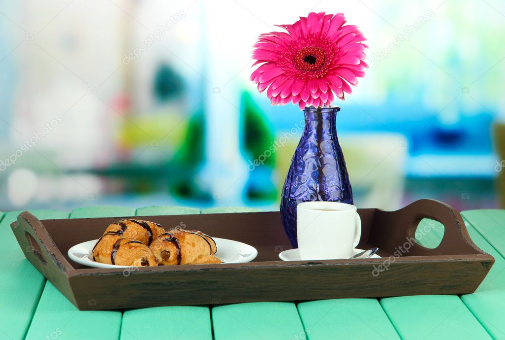 Wooden tray with breakfast, on bright background