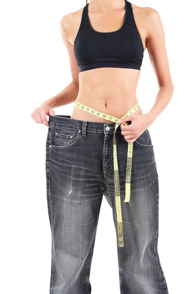 Slim girl in big jeans isolated on white — Stock Photo, Image