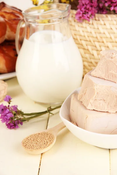 Dry yeast with pastry and baking ingredients on wooden table close-up — Stock Photo, Image