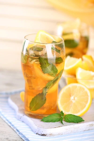 Ijsthee met citroen en mint op houten tafel — Stockfoto
