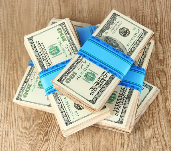 Stacks of money on wooden table — Stock Photo, Image