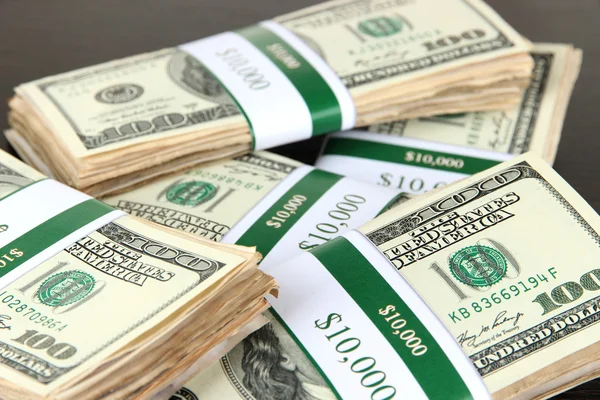 Stacks of money on wooden table — Stock Photo, Image