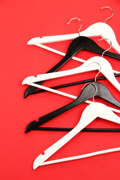 Black and white clothes hangers on color background — Stock Photo, Image