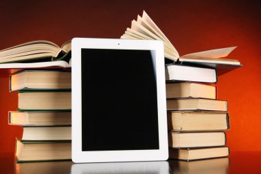 Tablet ve parlak zemin üzerine kitaplar