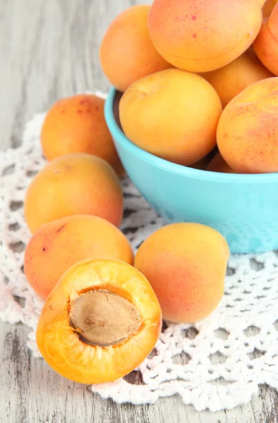 Fresh natural apricot in bowl on green wooden table — Stock Photo, Image