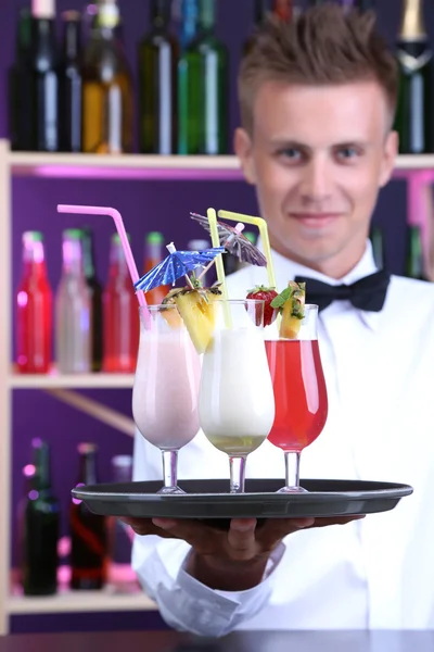 Portrait of handsome barman with different cocktails cocktail, at bar — Stock Photo, Image