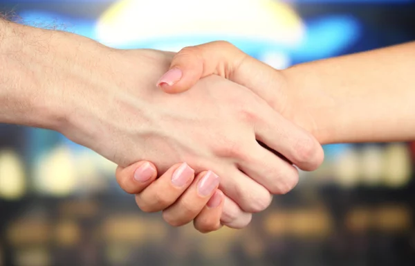 Handshake on bright background — Stock Photo, Image