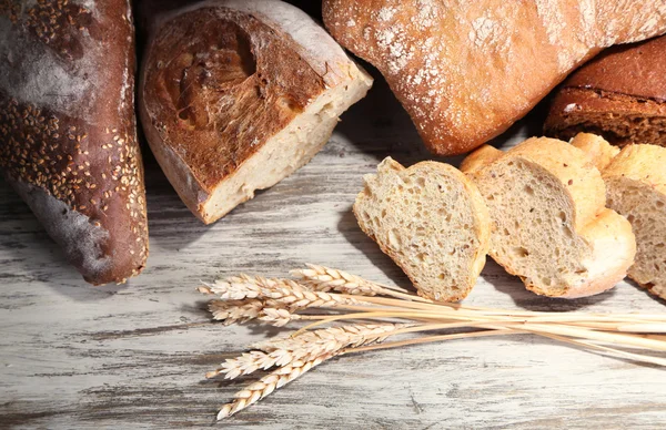 Much bread on wooden board — Stock Photo, Image