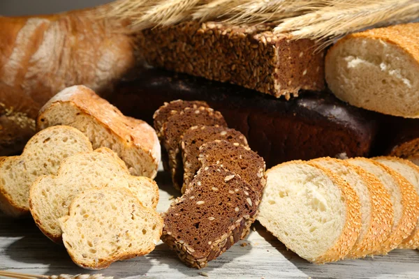 Much bread on wooden board — Stock Photo, Image