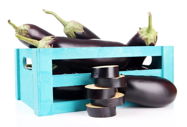 Fresh eggplants in wooden box isolated on white — Stok fotoğraf