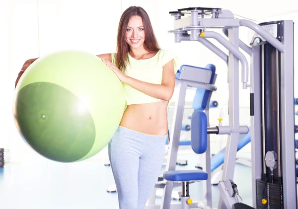 Pretty sporty girl with fit-ball in gum — Stock Photo, Image