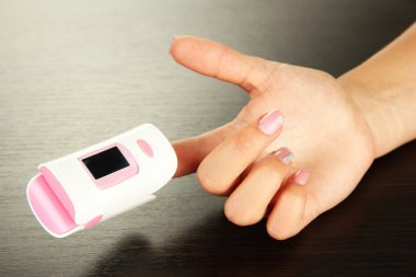 pulse oksimetre ahşap zemin üzerinde nabız ve oksijen oranı düzeylerini ölçmek için kullanılan