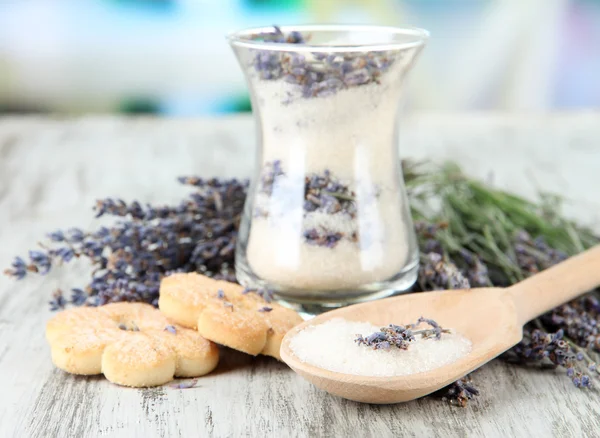 Glass of lavender sugar and fresh lavender flowers on bright background — Stock Photo, Image