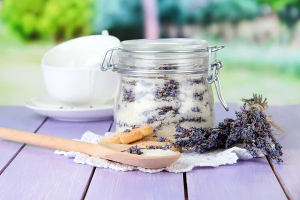 Jar of lavender sugar and fresh lavender flowers on bright background — Stock Photo, Image