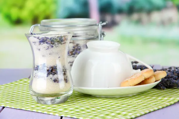 Jar of lavender sugar and fresh lavender flowers on bright background — Stock Photo, Image