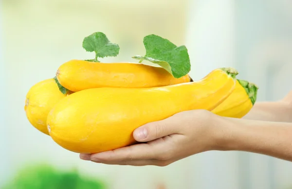 Woman hand holding raw zucchini, outdoors — Stock Photo, Image