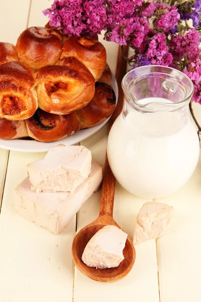 Dry yeast with pastry on wooden table close-up — Stock Photo, Image