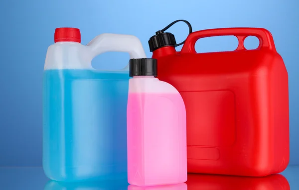 Liquids for car in canisters on blue background — Stock Photo, Image