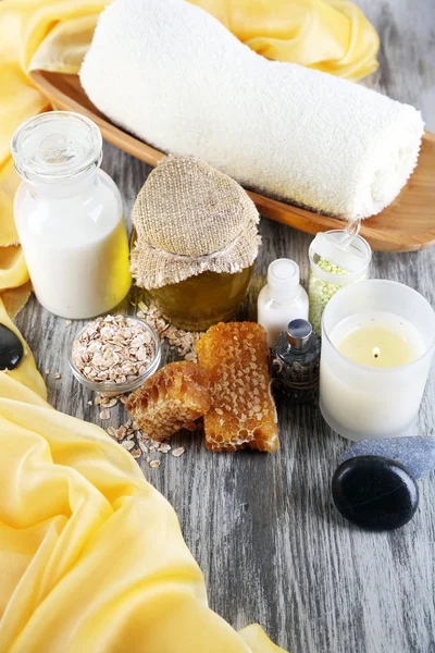 Медовый и молочный спа с маслами и медом на деревянном столе крупным планом — стоковое фото