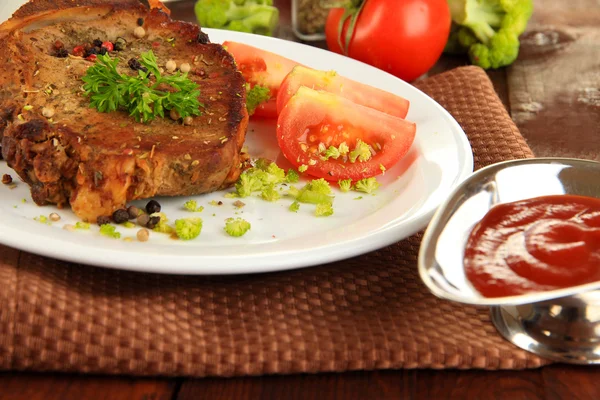 Piece of fried meat on plate on wooden table close-up — Stock Photo, Image