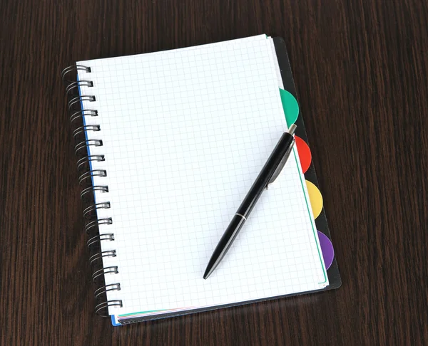 Notebook and pen on wooden table — Stock Photo, Image