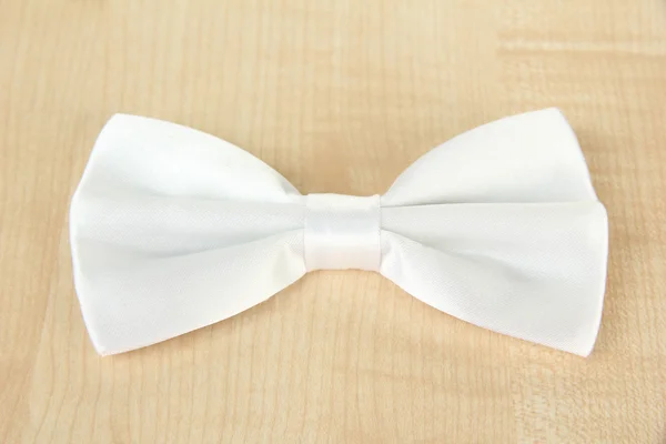 White bow tie on wooden background — Stock Photo, Image