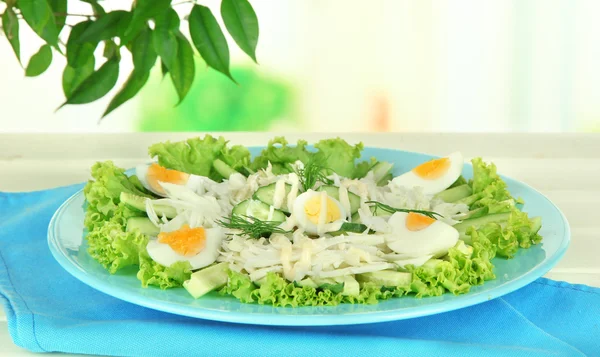 Delicious salad with eggs, cabbage and cucumbers on table — Stock Photo, Image