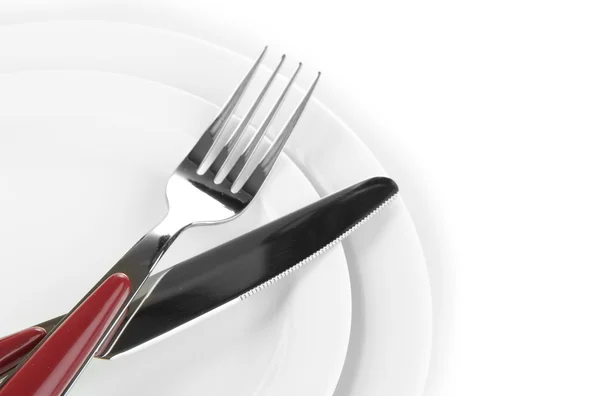 Knife, color plate and fork, isolated on white Royalty Free Stock Photos