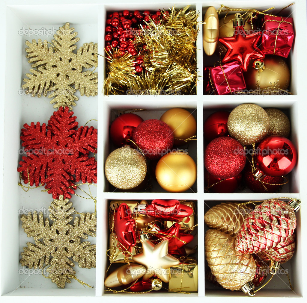 Wooden box filled with christmas decorations, on color wooden background