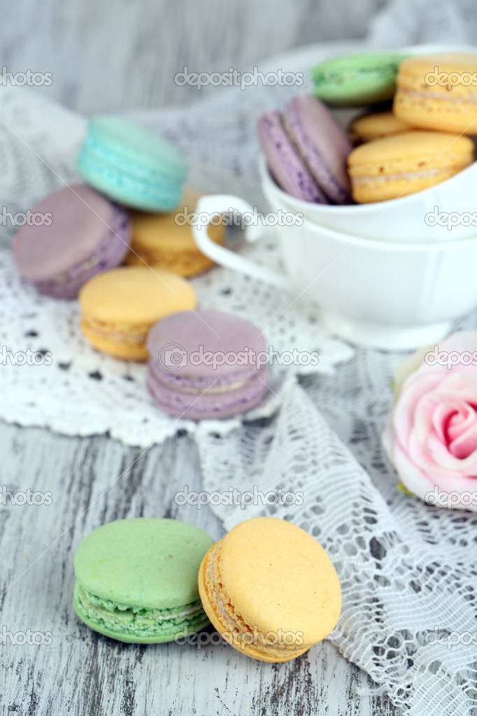 Macaroons in bowl on wooden table close-up