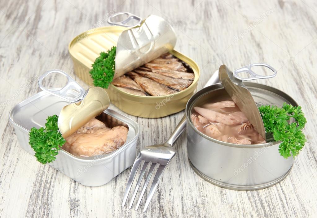 Open tin can, on wooden background